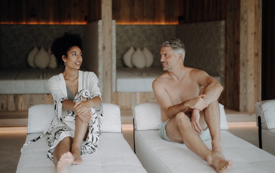 Ein Mann und eine Frau sitzen entspannt auf Liegest&uuml;hlen und unterhalten sich